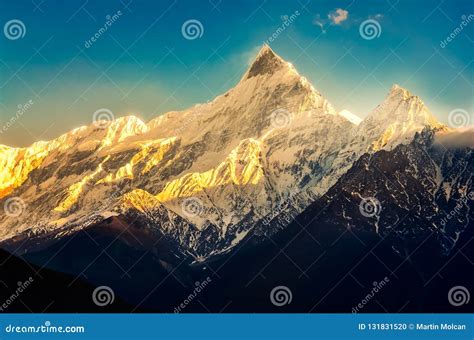 Mountain Peaks With Snow And Blue Sky At Colorful Sunset With Sunrays