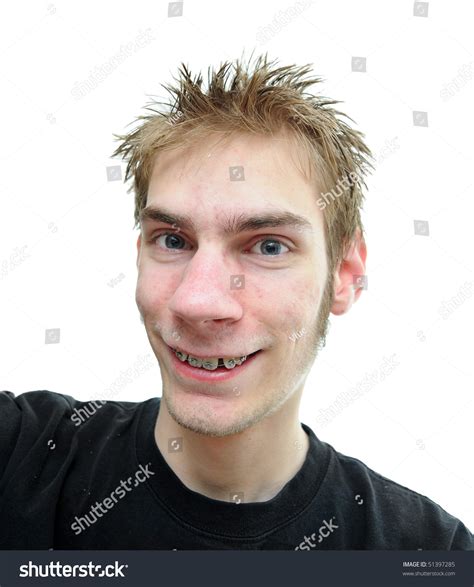 An Average Looking Young Adult Smiles At The Camera With Slightly
