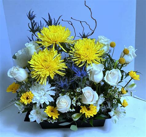 Remembering the desegregation of law enforcement in west memphis, arkansas. Yellow chrysanthemum are paired w roses and blue thistle ...