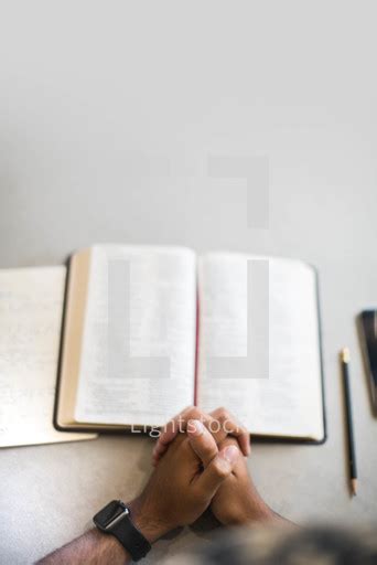 Praying Hands And Open Bible — Photo — Lightstock