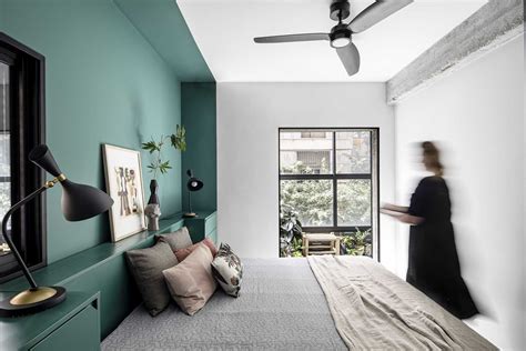 A Green Accent Wall Frames The Bed And Headboard In This Bedroom