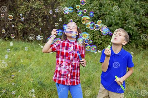 Kids Playing With Bubbles Stock Photo Image Of Meadow 104953950