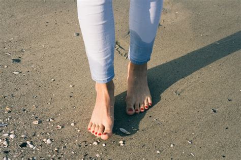 Premium Photo Bare Female Feet Walking On Wet Sand At Beach