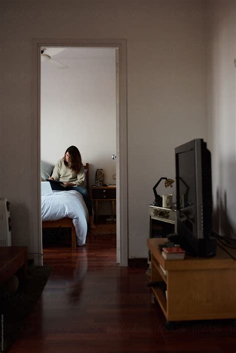 Brunette Woman Working In Bedroom By Stocksy Contributor Guille