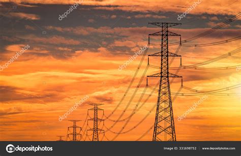 High Voltage Electric Pole And Transmission Line In The Evening