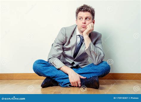 Sad Man Sitting In A Suit On The Floor In His House Stock Image Image