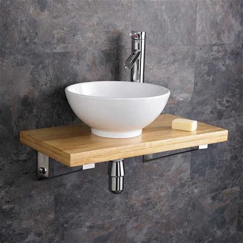 Bathroom sink with a durable wooden construction and rustic stylization. 32cm Ceramic Round Bathroom Sink 60cm Wood Shelf Wall Hung ...