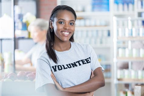 Together we can make sure everyone has the nutritious food they need to thrive. Portrait Of Confident Food Bank Volunteer Stock Photo ...