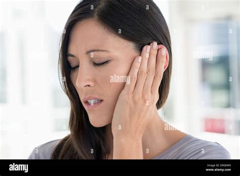 Woman Suffering From An Ear Ache Stock Photo Alamy