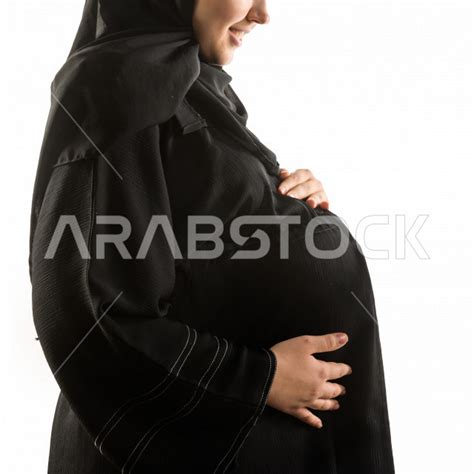 portrait of a pregnant saudi arabian gulf woman wearing a maternity abaya with different face