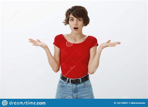 Shocked Confused Cute European Woman Short Pixie Haircut Shrugging Hands Spread Sideways Gasping