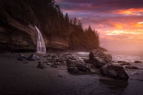 A Waterfall Flowing Onto The Beach Off The West Coast Of Vancouver