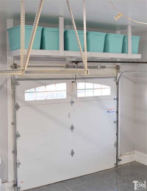 Make storage room in open space under the garage roof using basic carpentry skills and available building materials or manufactured garage storage racks. Overhead Garage Storage Shelf - Her Tool Belt