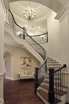 Not only do they bridge together rooms and stories within a house, but they're often the first space a guest encounters at the entryway. curved staircase. foyer. entryway. home decor and interior ...