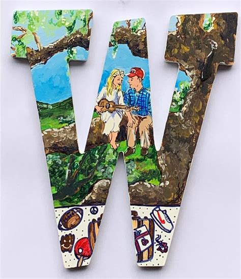 The Letter W Is Painted With Images Of People And Animals On Its Sides