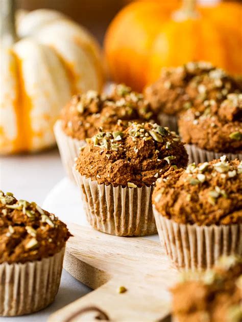 Several Muffins On A Plate With Pumpkins In The Background