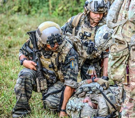 Two Us Army Green Berets Of The 5th Special Forces Group Examine A