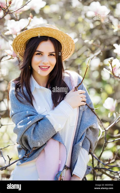 Pensive Beautiful Girl In Straw Hat Looking Up Smiling Holding Touching