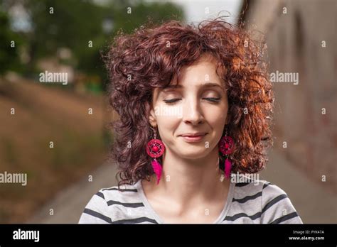 Curly Haired Women Outdoors With Her Eyes Closed Pretty Smile Stock