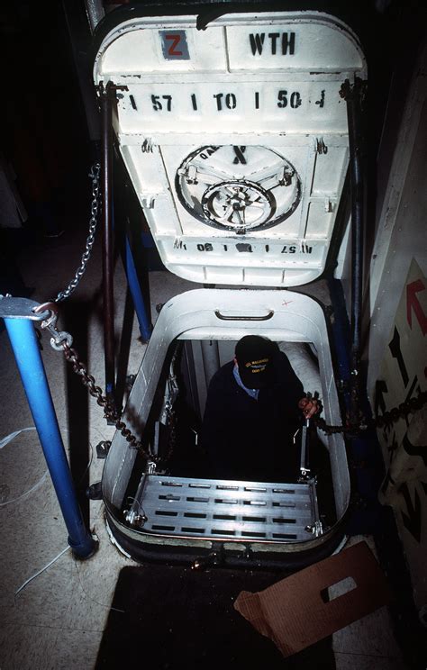 A Sailor Cleans The Ladder Leading Out Of A Compartment Aboard The