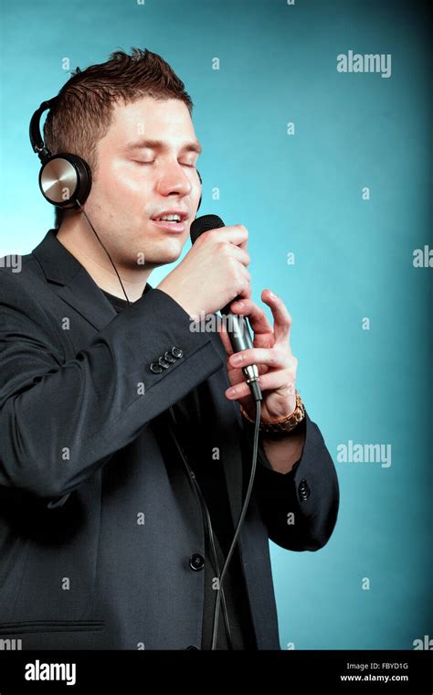 Man Singing Into Microphone Happy Karaoke Signer Stock Photo Alamy