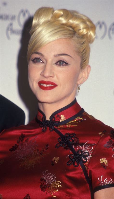 A Woman With Blonde Hair Wearing A Red Dress