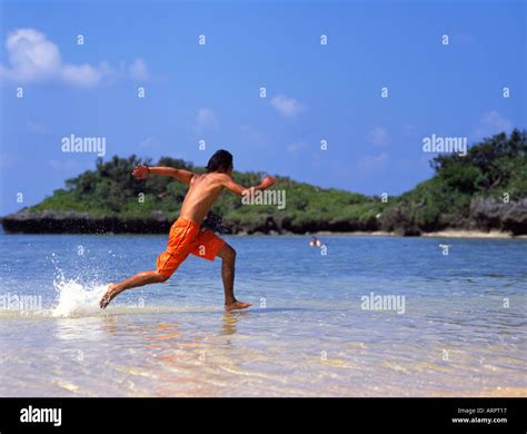 Handsome Japanese Man Sprints Across The Water At Hoshizuna Beach