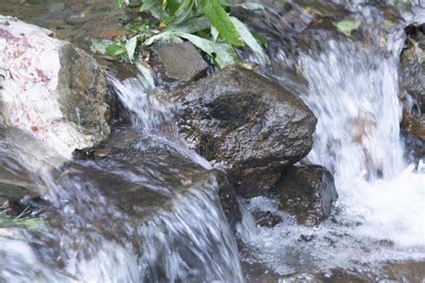 A Seething Stream Of Water Flows Over The Stone Boulders Stock Image