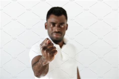 Close Up Portrait Of Angry Or Annoyed Black Man Making Fig Gesture