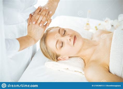 Beautiful Happy Woman Enjoying Facial Massage With Closed Eyes In Spa Salon Relaxing Treatment