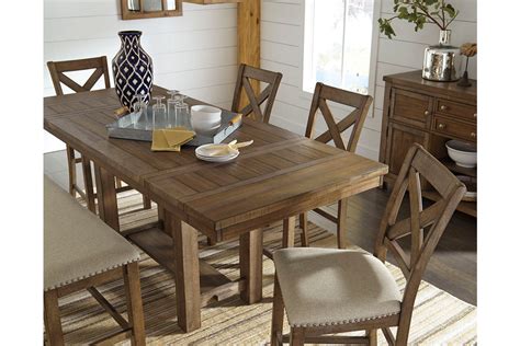 The most common tall dining table material is glass. Moriville Counter Height Dining Room Table by Ashley ...
