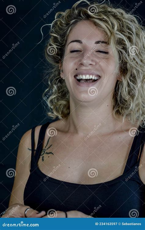 Portrait Of A Beautiful Young Woman With Blond Curly Hair Laughing Happily Stock Image Image
