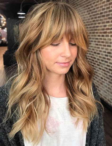 18 honey bronde shaggy hairstyle with bangs shaggy waves with longer bangs are so versatile