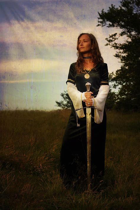 Mystical Medieval Woman Standing With A Sword On A Wild Meadow