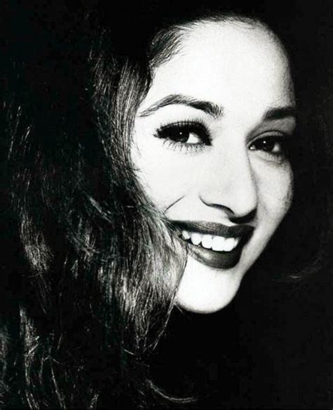 A Black And White Photo Of A Woman Smiling