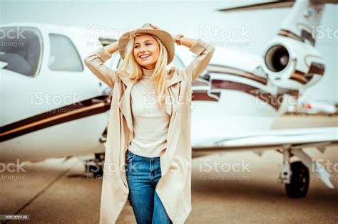 Rich Blonde Girl Walking Away From A Private Airplane Parked On An