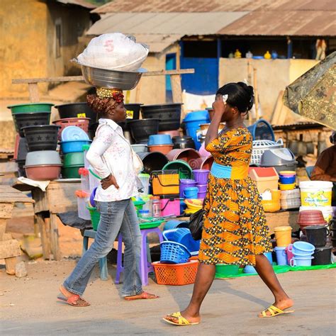Unidentified Ghanaian Women Walk Along The Market In Local Vill