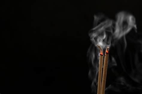 Premium Photo Incense Sticks And Incense Stick Smoke On Black Background