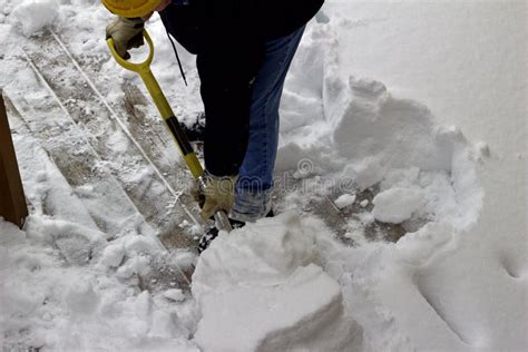 Shoveling Deep Snow In Driveway Of House With Car Half Buried Stock