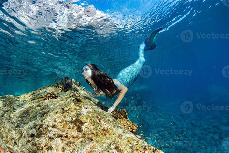 Mermaid Swimming Underwater In The Deep Blue Sea 12201685 Stock Photo