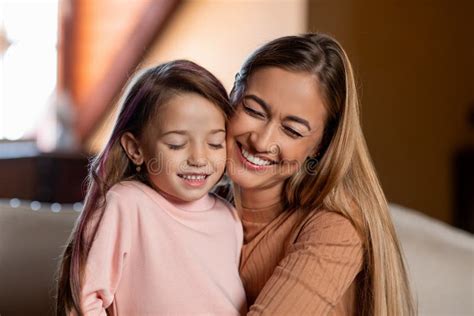 Portrait Of Happy Mom And Daughter Hugging At Home Stock Photo Image