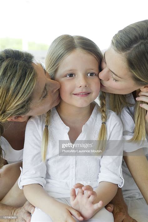 Girl Being Kissed On Cheek By Mother And Grandmother Photo Getty Images