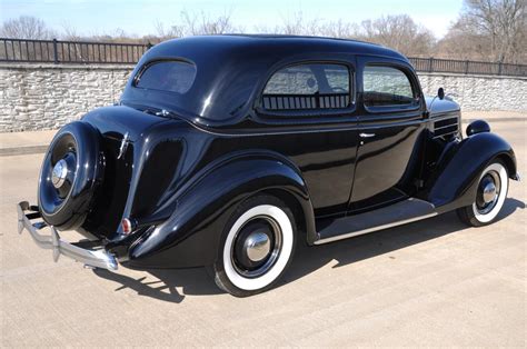The pink car definitely does not have two piece front fenders and there are no chrome grills, or the holes for them, in the front. 1936 Ford Tudor Sedan Humpback V8 Flatty