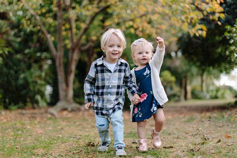 Brother And Sister Holding Hands Walking Together By Stocksy Contributor Jakob Lagerstedt