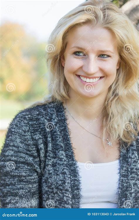 Portrait Of Smiling Woman Looking On The Side Of The Camera Stock Image
