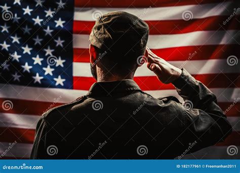 Memorial Day A Uniformed Soldier Salutes Against The Background Of The