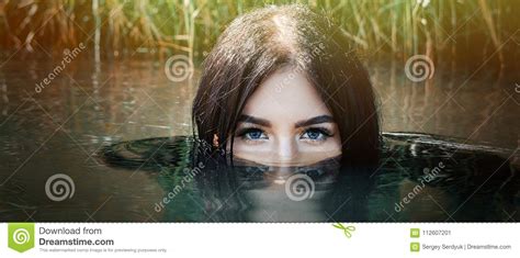 A Woman Or Girl Floating In The Water Only The Eyes Are V Stock Image