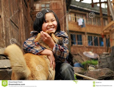 The Rural Chinese Teenage Girl Plays With The Ginger Dog