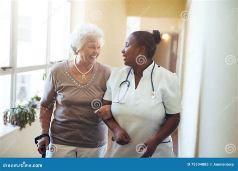 Nurse Assisting Senior Woman At Nursing Home Stock Image Image Of