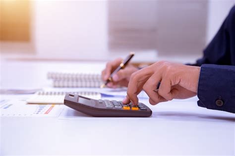 Premium Photo Businessman Working On A Desk With A Calculator To